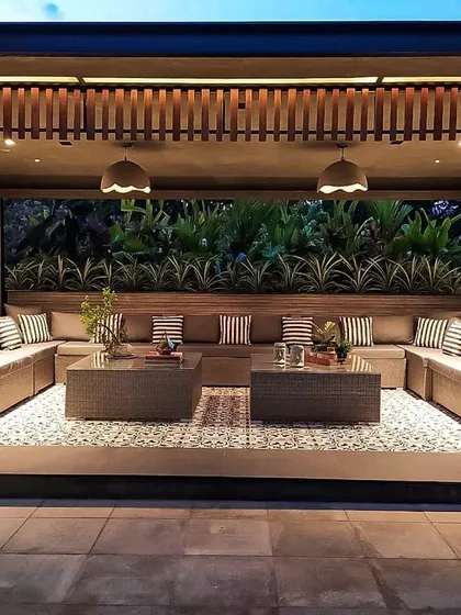 A view of the main seating area on the Chhabria's Terrace. The large U-shaped sofa is set against a backdrop of vertical gardens, creating a cozy and intimate gathering space with a strong connection to nature.