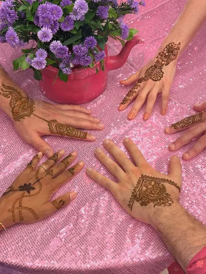 A group of friends showing off their party mehendi. We offer a variety of styles to suit everyone's taste.