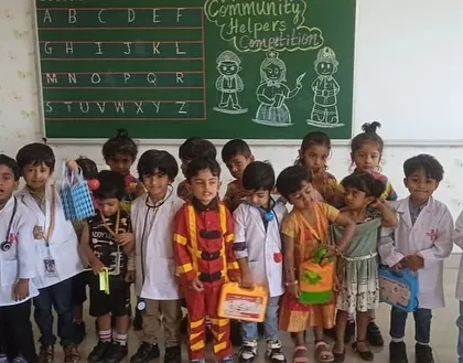 A group of preschoolers in their community helper costumes, including a firefighter and several doctors, ready for a day of learning.