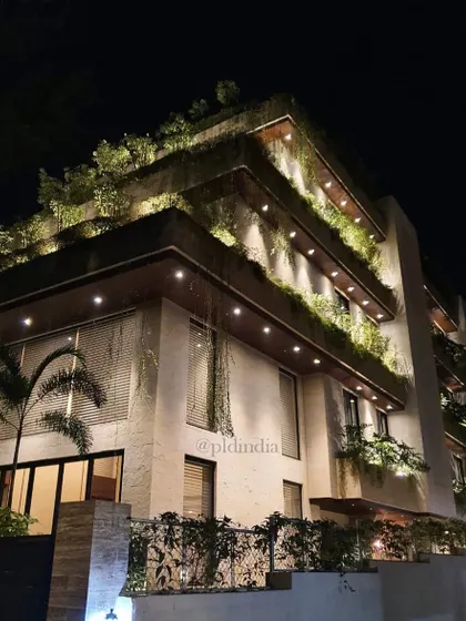 At night, strategic landscape lighting illuminates the building's green facade. This not only enhances the architectural beauty but also creates a warm and inviting ambiance, making the building a beacon in the neighborhood.
