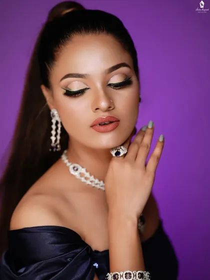 The focus here is on the glowing skin and the sharp, winged eyeliner.