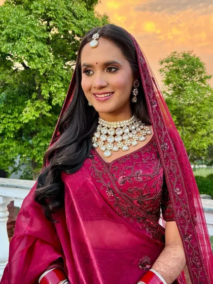 A beautiful bride against the sunset. Her makeup is designed to look stunning in the magical golden hour light.