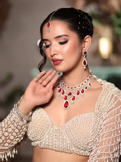 A close-up on the soft, shimmery eye makeup and the bold ruby jewelry, a perfect combination for an evening function.