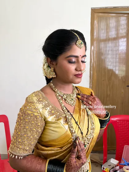 Another angle of this beautiful bride, showing how the layered necklaces sit perfectly with her golden silk saree.