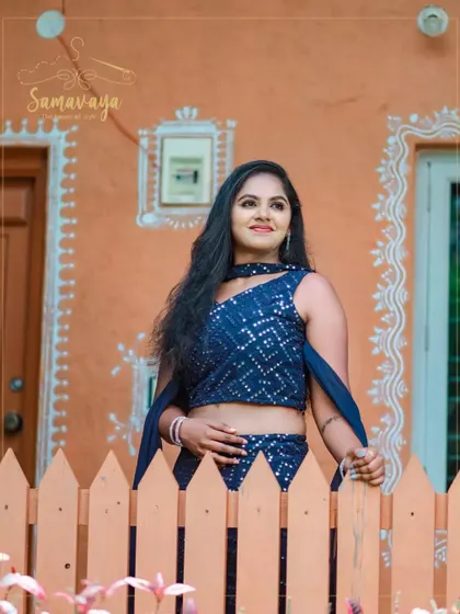 A portrait against a traditional Indian-style wall, showing how versatile an outfit can be in different outdoor settings.