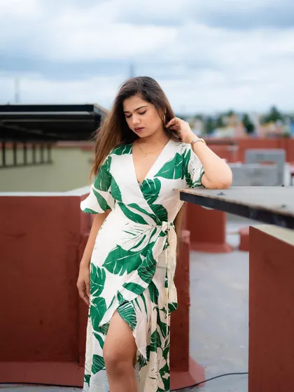 A rooftop portrait with a beautiful view of the city. The model's pose and the open sky create a sense of freedom and style.