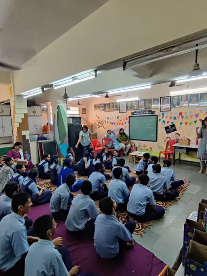 A wide view of a classroom session, showing students seated on the floor, ready and eager for their next hands-on STEM adventure.