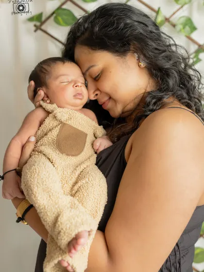 A mother's love in its purest form. This quiet, intimate moment between a mom and her sleeping newborn is a powerful and timeless image of their unbreakable bond.