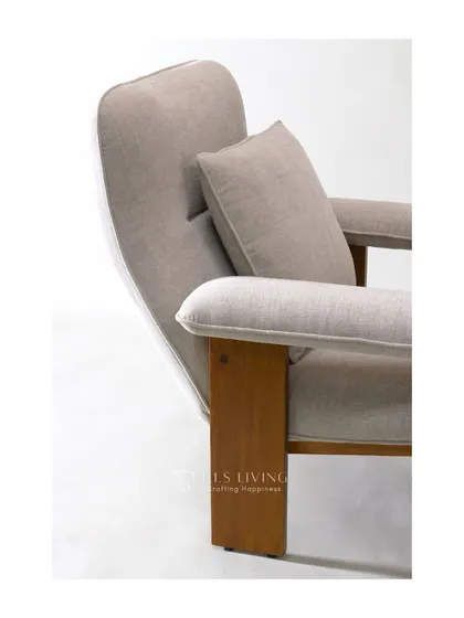 This mid-century wooden armchair features a solid wood frame and plush, neutral-colored cushions. Its simple, honest design is both elegant and incredibly comfortable.