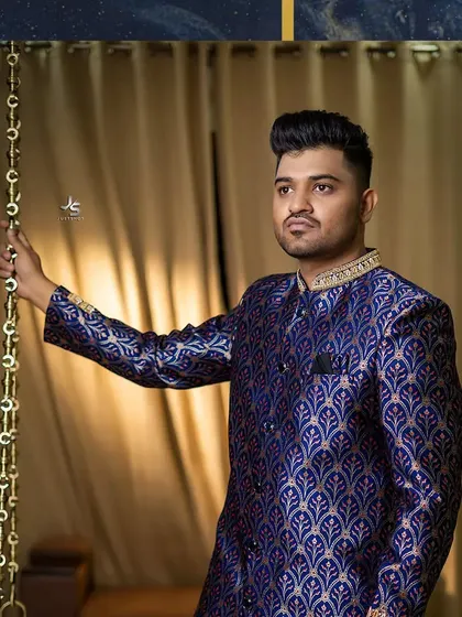 The groom's royal blue brocade sherwani, a statement piece for any wedding event.