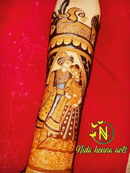 A detailed figurative design on the forearm, capturing an intimate moment between the bride and groom.