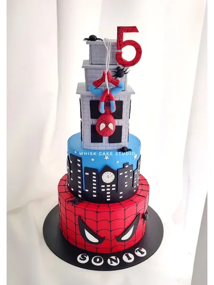 A grand, multi-tiered Spider-Man cake. This impressive design features different Spidey-themed elements on each tier, perfect for a big superhero celebration.