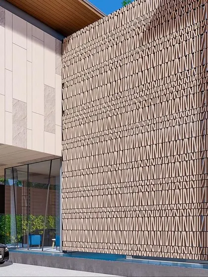 A wider view of the limestone jali facade in Goa. The woven pattern creates a stunning textural effect that changes with the light throughout the day, elevating the building's exterior into a work of art.