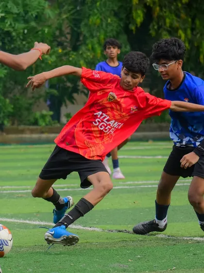 A player trying to dribble through a crowded midfield, showcasing agility and close control.