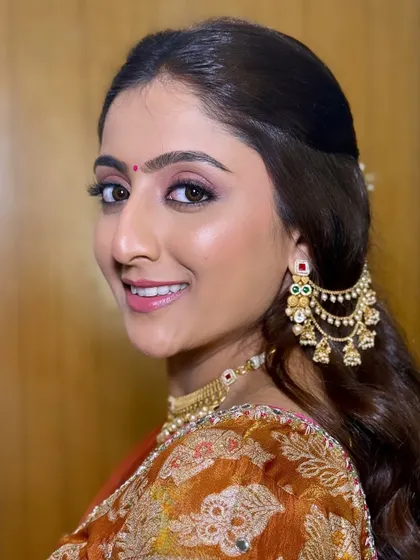 A happy, smiling portrait. Her eyes are the focus, with a beautiful blend of colors that make them sparkle.