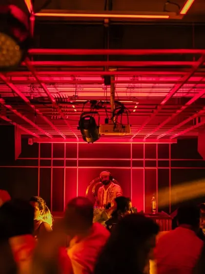 A wide shot of the console at Gawky Goose, with the crowd ready for a night of smashing Bollywood tunes.