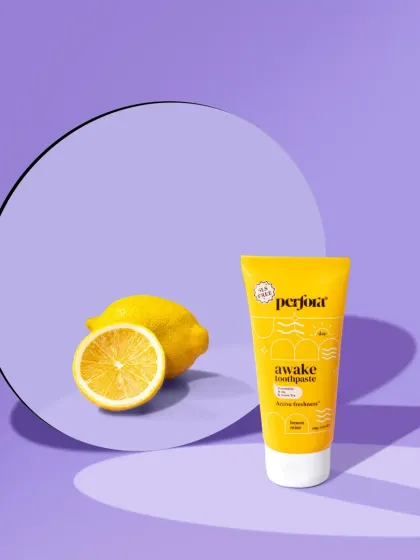 A vibrant shot for Perfora's "Awake" toothpaste. The bright yellow and purple color scheme, along with the fresh lemon, creates an energetic and zesty visual.