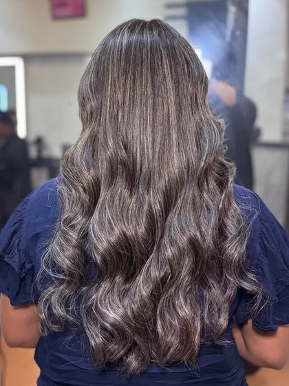 The back view of the creamy ash color, showing off the healthy shine and soft waves.