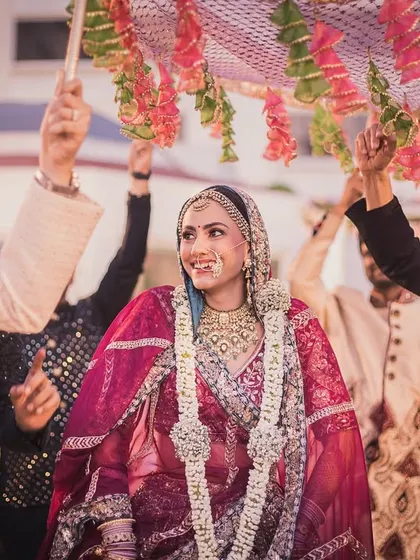 The bride's entrance under the 'phoolon ki chadar', a beautiful and emotional tradition we love to photograph.