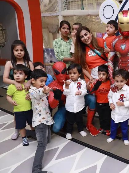 A big group photo with both Spiderman and Iron Man. Having two heroes at the party doubles the excitement for the kids.