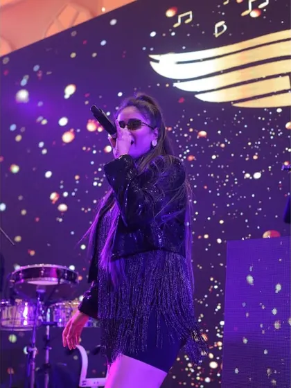 Our female vocalist, captivating the audience with her powerful voice and stage presence. She brings a unique flair and energy to our performances.