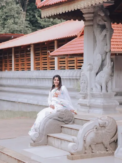 A series of peaceful portraits taken at a temple. The model's white saree contrasts beautifully with the intricate stone architecture, creating a sense of calm and serenity.