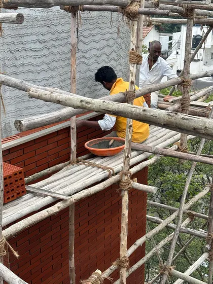A series showing masons meticulously laying bricks for a facade. Achieving a perfect finish requires incredible skill and patience, and we have immense respect for the craftspeople who bring our designs to life.