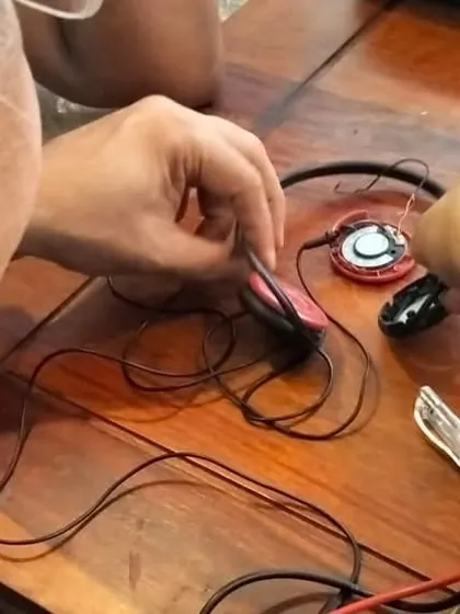 This close-up shows the delicate process of repairing a pair of headphones. Even small gadgets can be fixed, and we teach the fine motor skills needed for these intricate repairs.