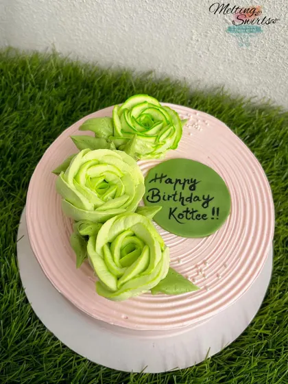 Another example of our floral piping, this time with vibrant green whipped cream roses on a pink cake.