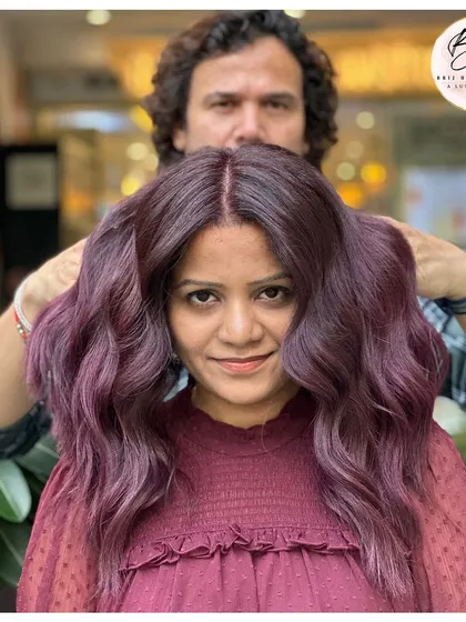 The client looking stunning with her new grape wine hair color, a perfect blend of bold and beautiful.