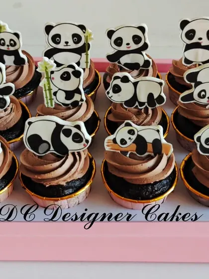 An adorable set of panda-themed cupcakes for an 11th birthday. Each chocolate cupcake is topped with a different cute panda cutout, perfect for an animal lover's party.
