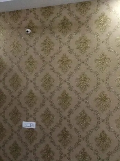 A gold damask wallpaper with a slightly different pattern.