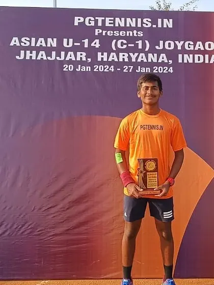 Ishaan Yadlapalli with his finalist trophy in boys' doubles at the Asian Tennis Championships in Jhajjar. Performing at this level consistently is a key benchmark of our program.