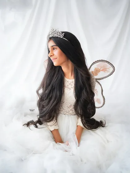 A serene and graceful portrait of an older sister dressed as a beautiful fairy.