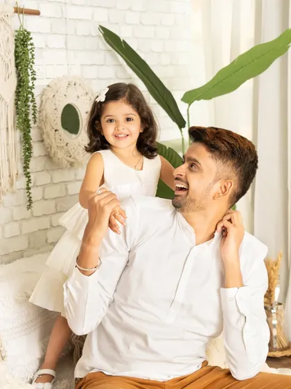 A candid moment of laughter and love between a father and his daughter. These natural, unposed shots are often the most precious.