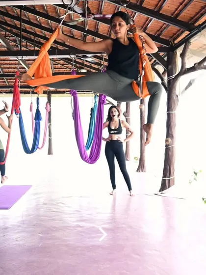 Finding her power and grace in the air. It's incredible to witness students embrace the challenge and beauty of aerial yoga during our retreats.