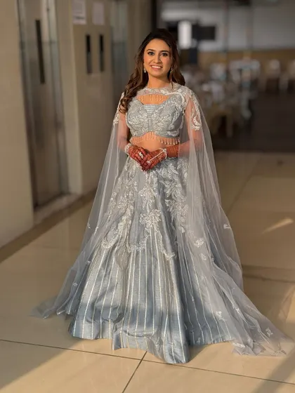 A full-length shot showing the beautiful silhouette of the sangeet outfit. The hair and makeup complete this modern, elegant look.