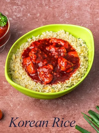 Our take on Korean Rice features fluffy fried rice topped with chicken cooked in a sweet and spicy red sauce, inspired by popular Korean flavors.