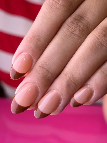 A warm and sophisticated French manicure. This look features a rich, caramel brown tip on a classic sheer base for a chic and understated style.