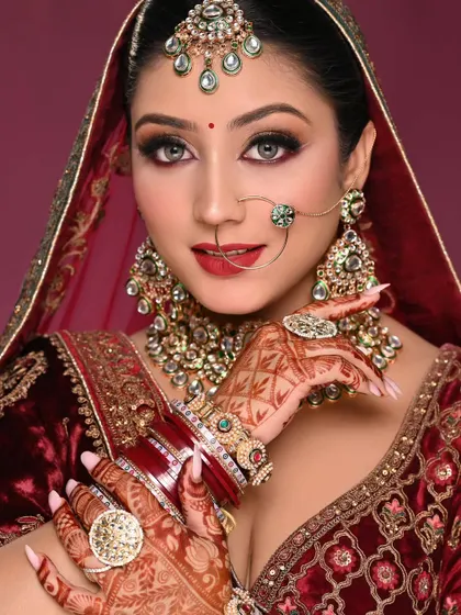 This shot captures the beautiful details of the henna and the rings, with the makeup providing a stunning backdrop.