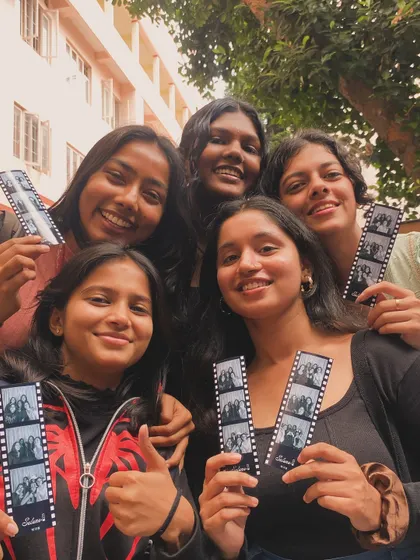 A group of five friends, all with their own photo strips to remember the day.