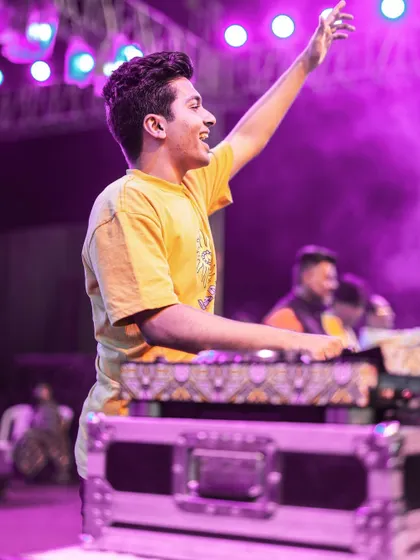 Hyping up the Navratri crowd. These large-scale events are about creating a collective celebration.