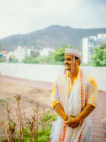 A candid portrait of the groom, glowing with turmeric and happiness.