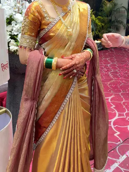A close-up of the perfectly pleated Kanjivaram silk saree. Notice the clean lines of the hip pleats, designed to flatter the silhouette.