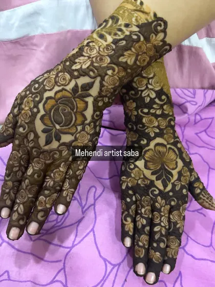 A full view of the design with the large central flower, showcasing the different but complementary patterns on each hand.
