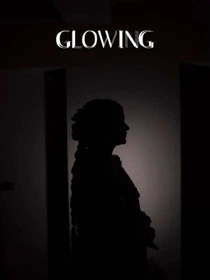 A creative silhouette portrait of the bride, highlighting her profile and traditional hairstyle.