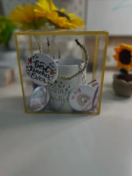 A close-up of the Star Teacher Mini Hamper, showing the custom mug and keychains neatly arranged in a transparent gift box.