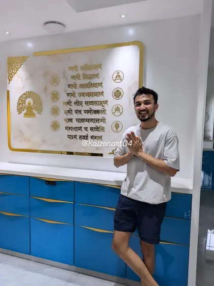 This large 5.5 by 3.5 feet Navkar Mantra frame is installed in a client's home, becoming the focal point of the room. The marble-themed background and golden acrylic details create a luxurious and spiritual ambiance.