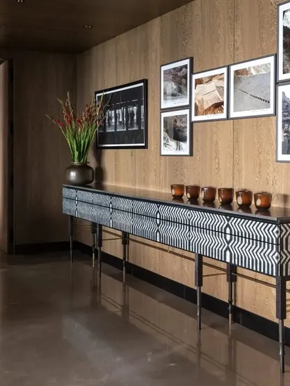 The 'Missoni Console' in the Caitriona apartment, an eleven-foot sideboard showcasing the pietra dura technique in mother of pearl and ebony. It is a masterpiece of craftsmanship and a stunning focal point.
