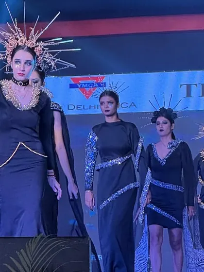 Models showcase a collection featuring intricate headpieces and elegant black gowns.